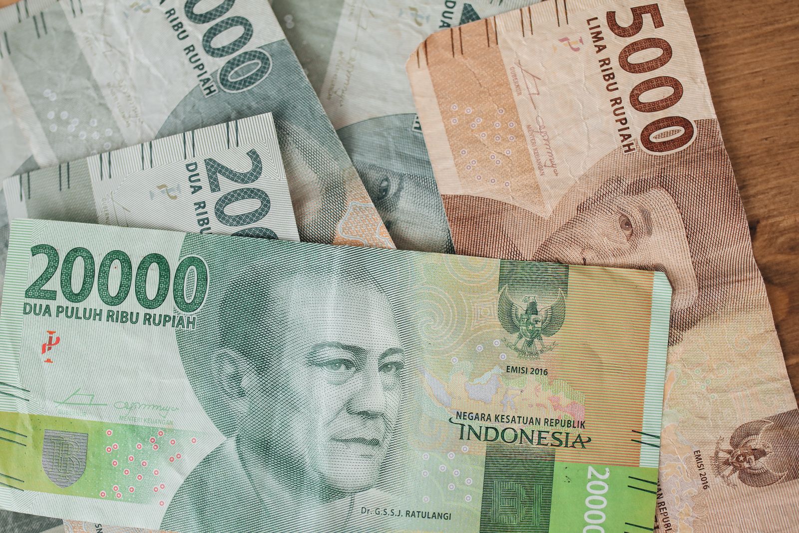 Indonesian rupiah banknotes in different denominations spread out on a table