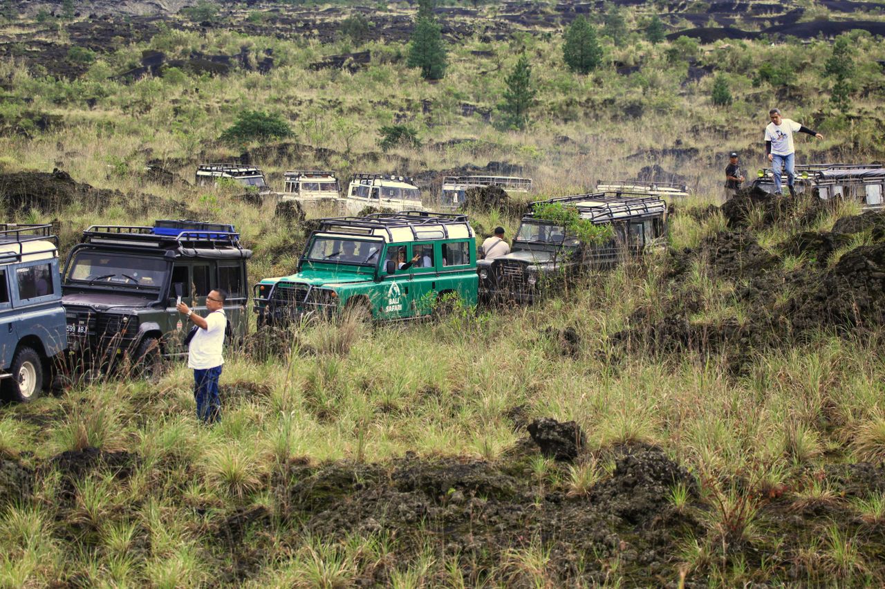 Off-road jeeps in a volcanic Bali landscape, the kind used on a Mount Batur sunrise jeep tour